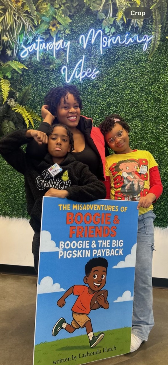 Family photo moment with the Boogie & Friends hero sign