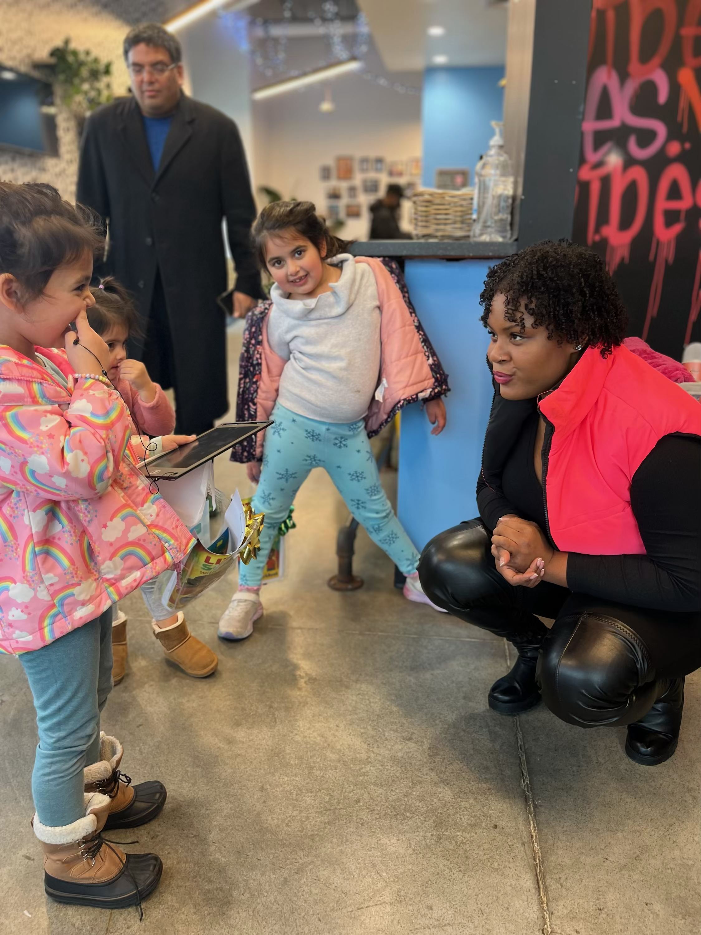 Tropikana sharing a moment with young readers