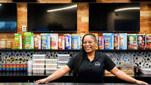 Owner of Saturday Morning Vibes Cereal Bar behind the counter