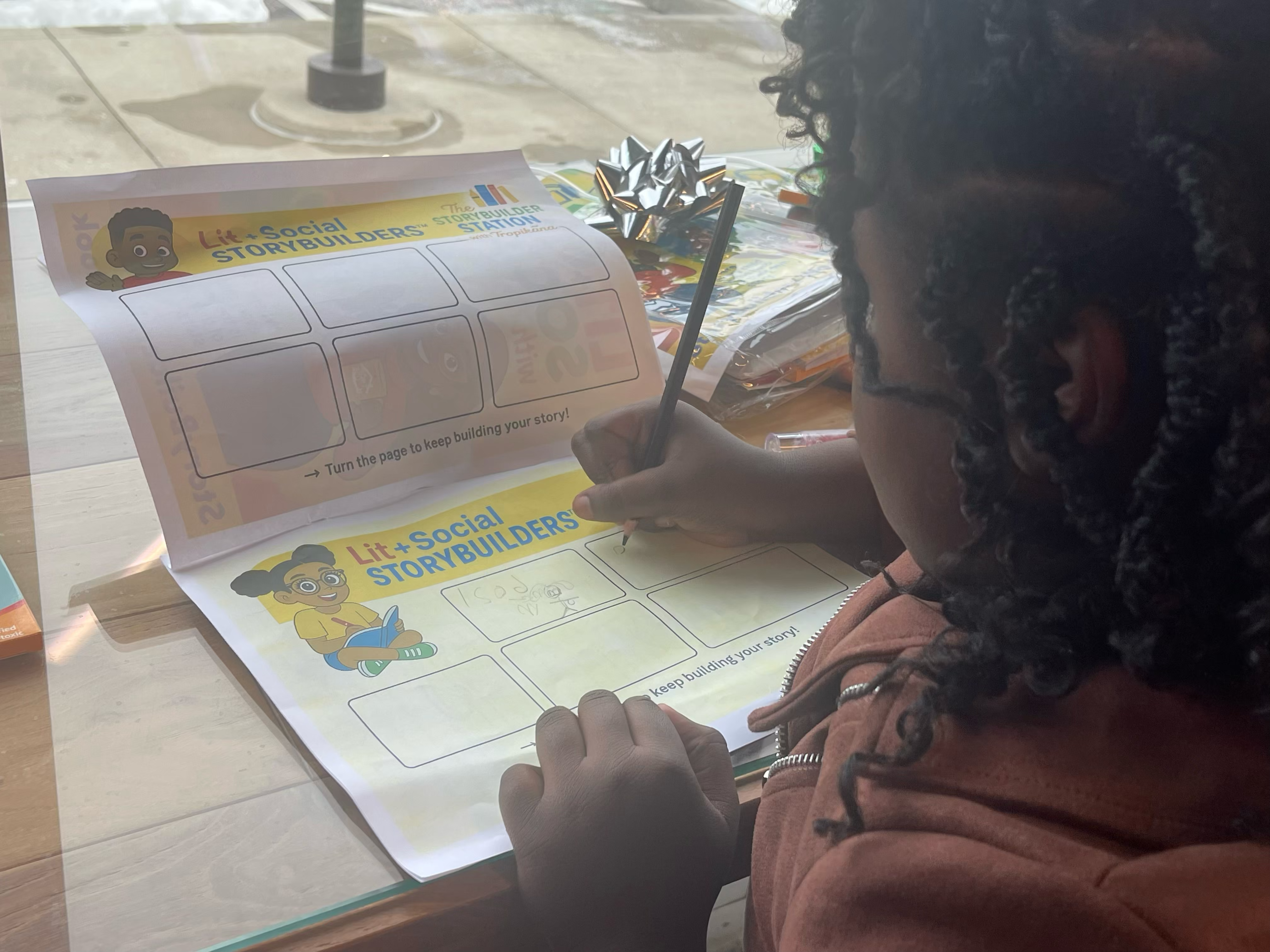 Child completing a Storybuilders worksheet
